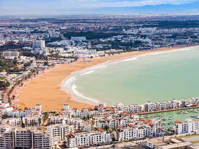 Agadir beach promenade with golden sand and modern resort hotels in southern Morocco