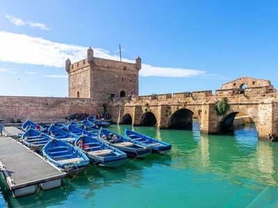 Essaouira medina ramparts overlooking the Atlantic Ocean and blue fishing boats