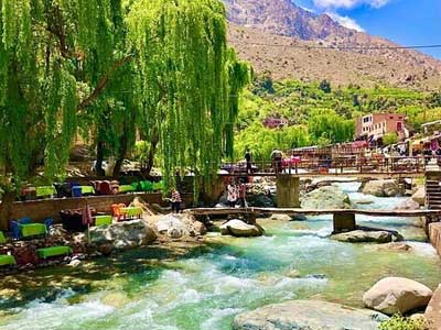 Lush green Ourika Valley with river waterfalls and traditional Berber hillside villages